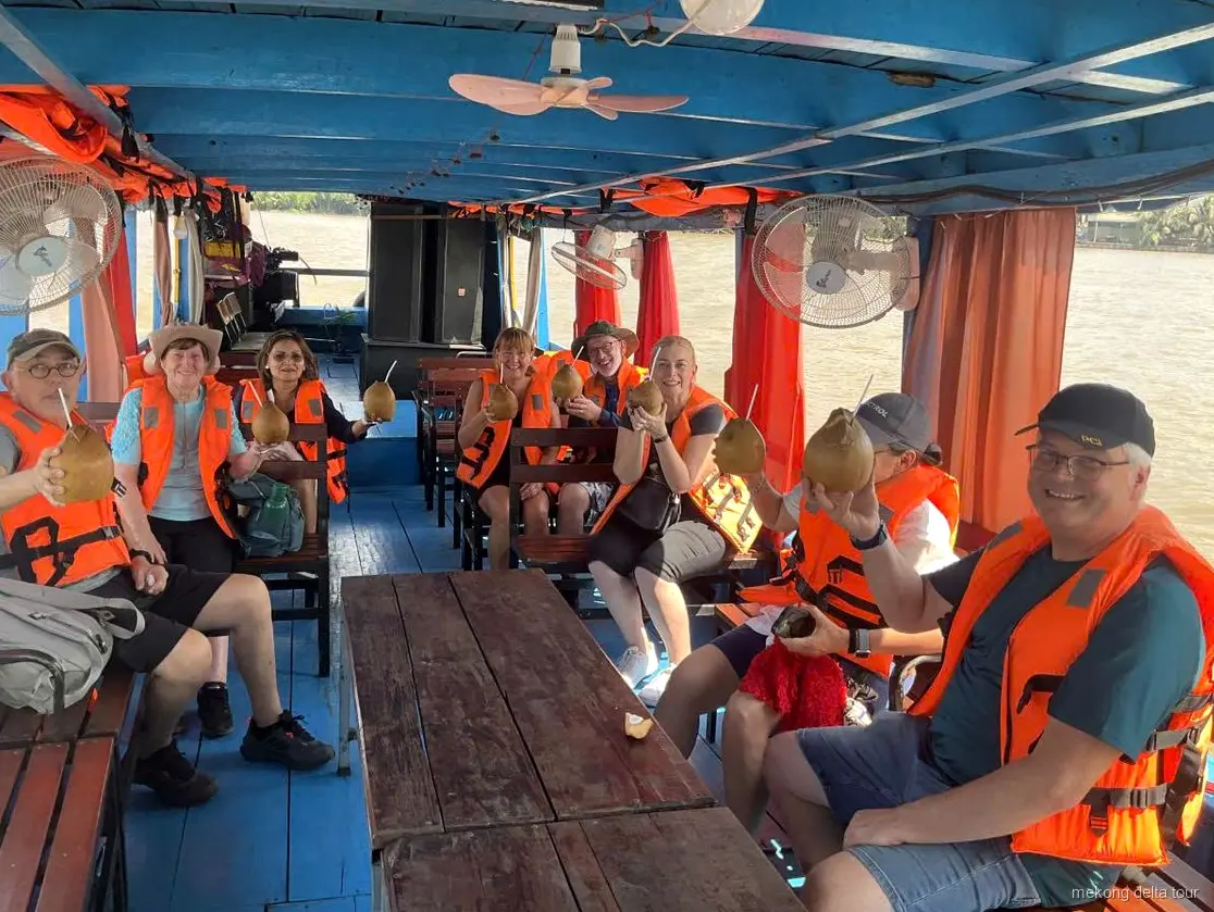 Hand-rowed sampan gliding through Mekong Delta canals on the combo tour