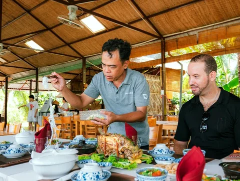 Wooden boat cruise on the Mekong River during the bike tour