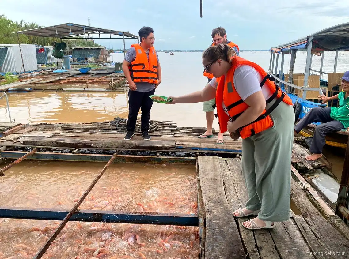 Motorboat cruise on the Mekong River near the floating fish farm